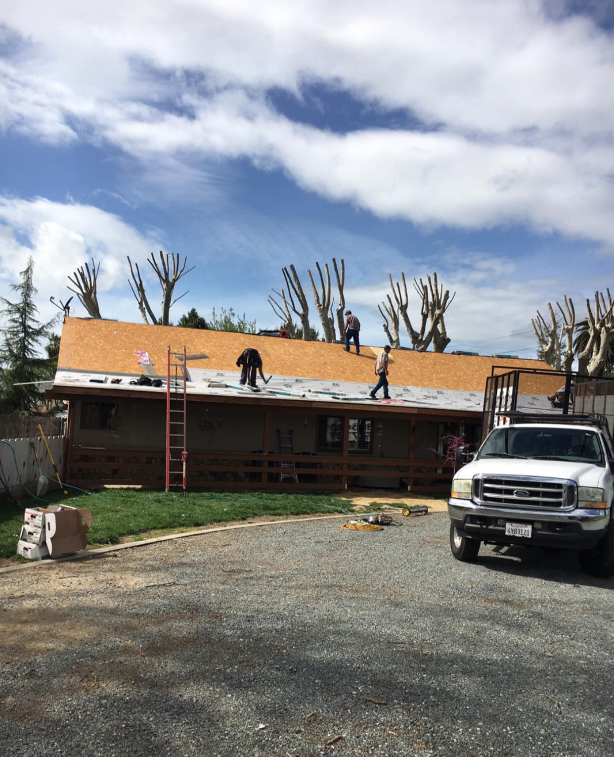 DeHart crew of three on a residential roof deck during a full replacement in Turlock