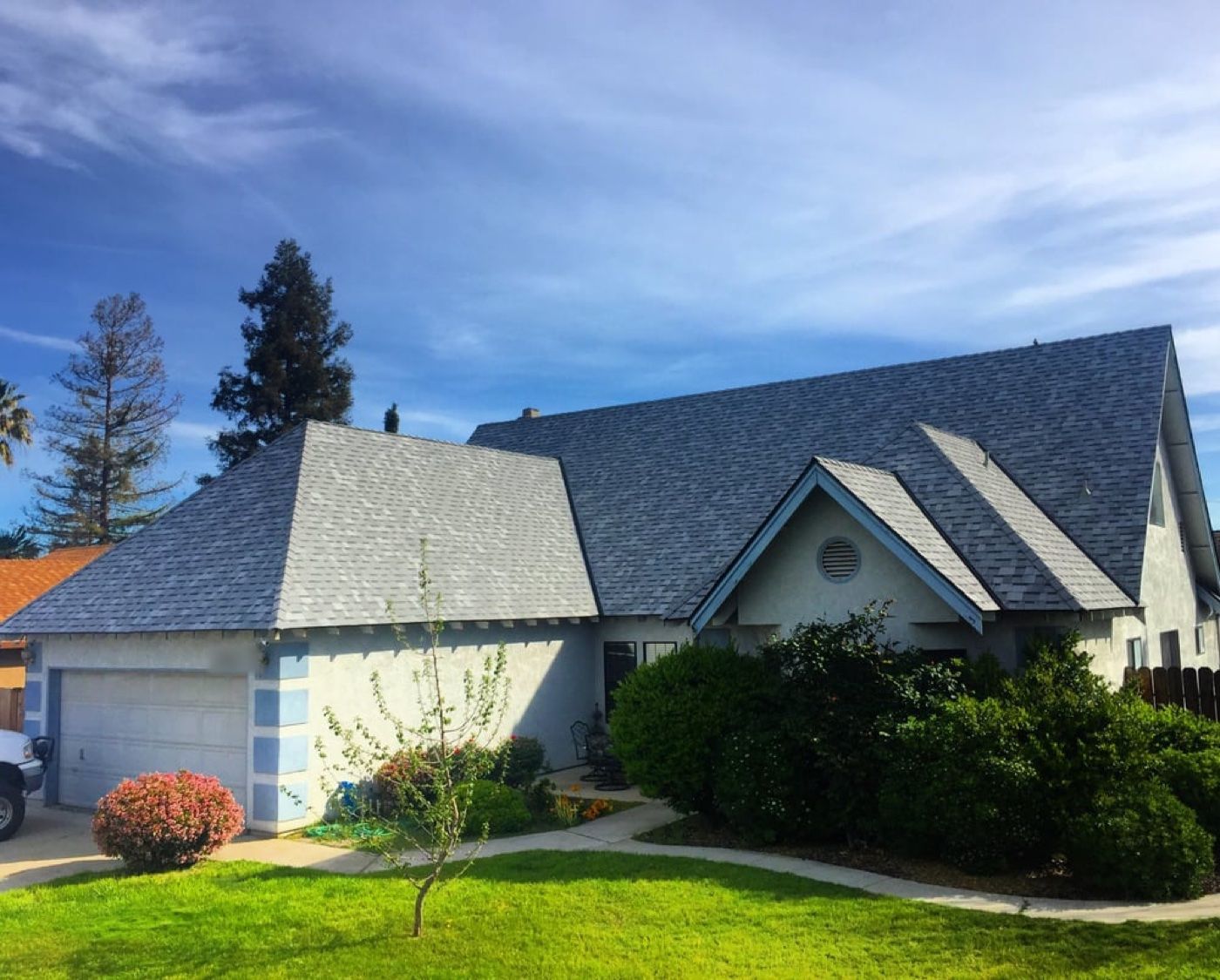Completed gray architectural-shingle roof on a French-country style home