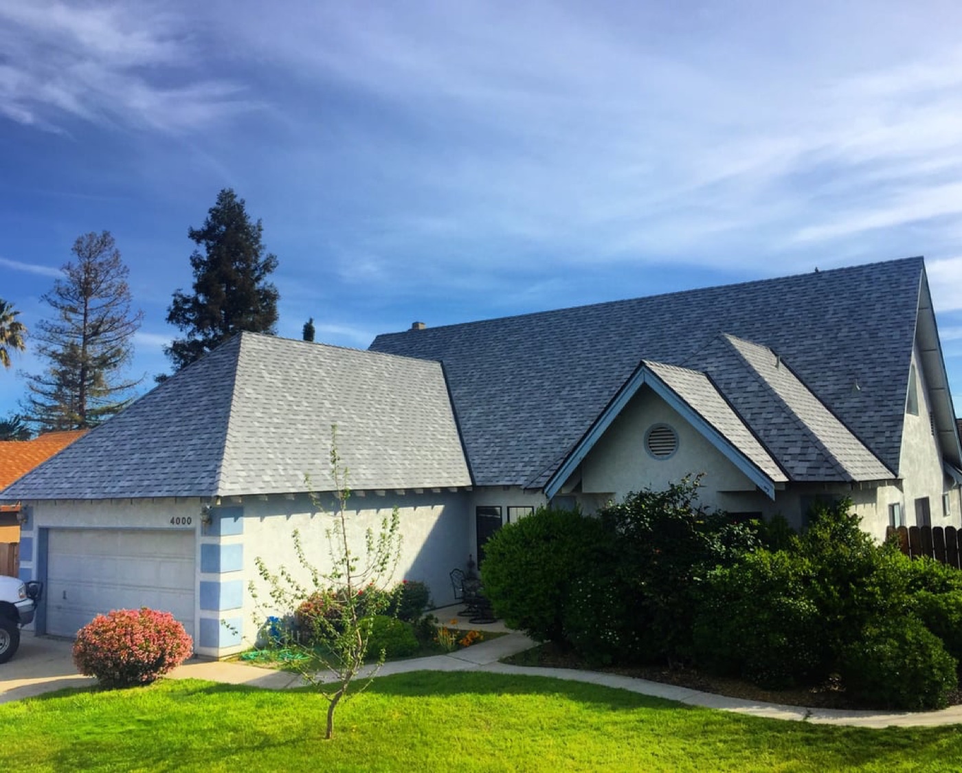 Completed gray architectural-shingle roof on a French-country style home