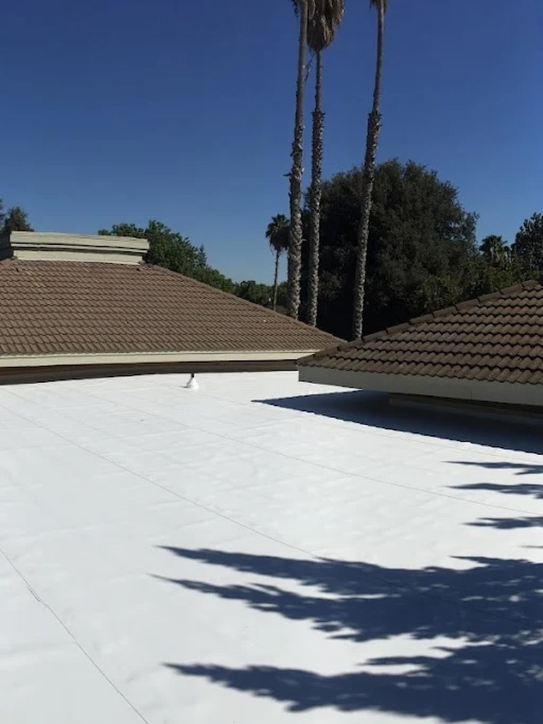 DeHart crew installing TPO flat roofing and edge metal flashing on a commercial property in the Central Valley